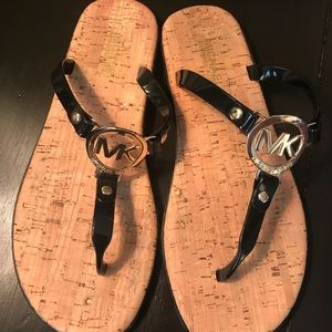 Black and gold Michael Kors flip flops